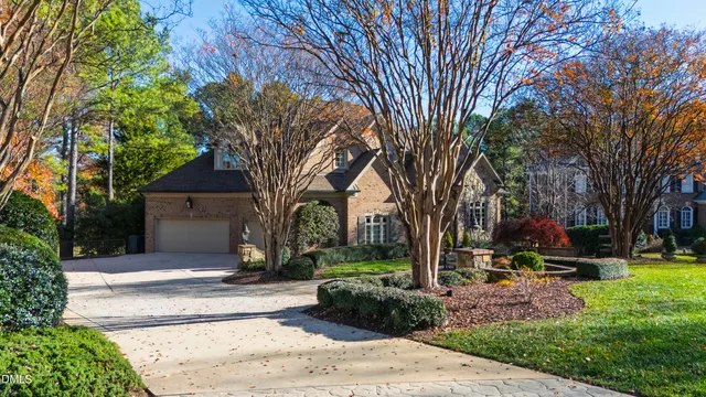 a front view of a house with a yard and fountain