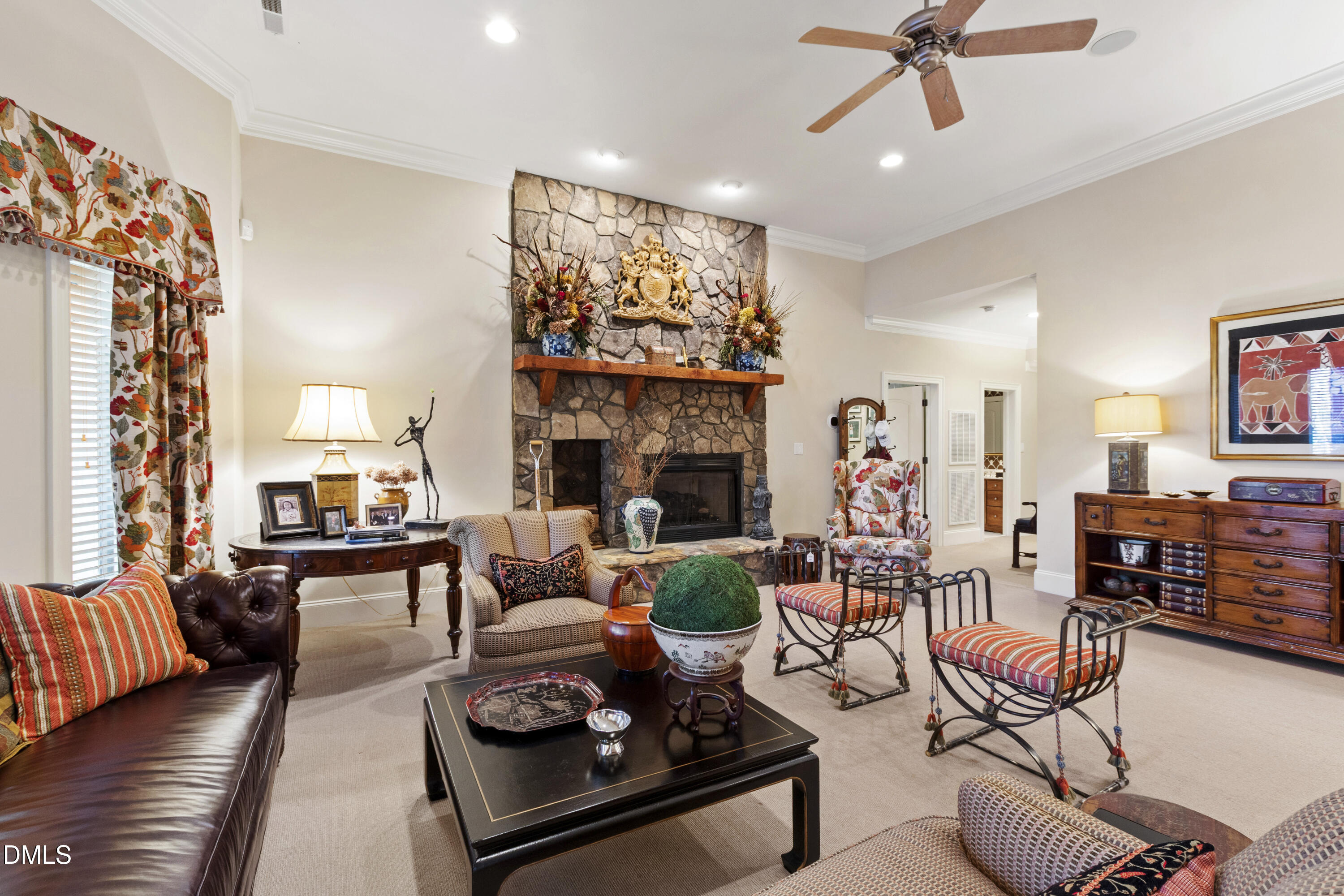 12345 Richmond Run Drive Raleigh, NC 27614 - Photo 61 of 98 a living room with furniture a fireplace and a chandelier