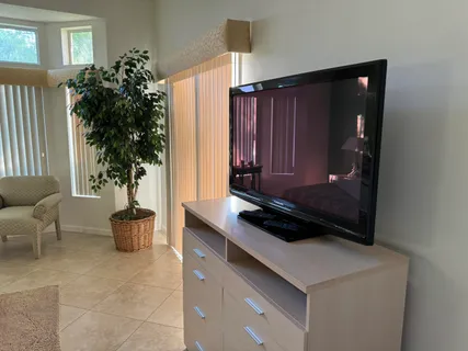 a kitchen with a refrigerator and a potted plant