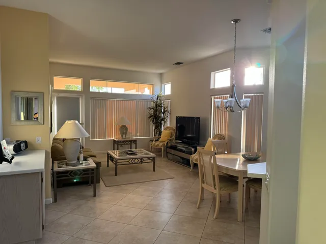 a living room with furniture a large window and a flat screen tv