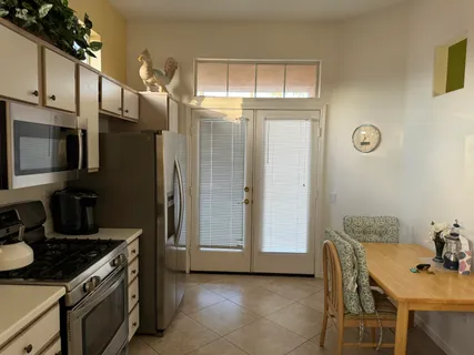 a kitchen with stainless steel appliances granite countertop a refrigerator and a stove top oven