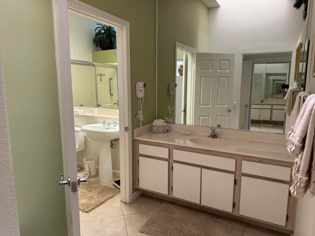 a bathroom with a granite countertop sink a mirror and a