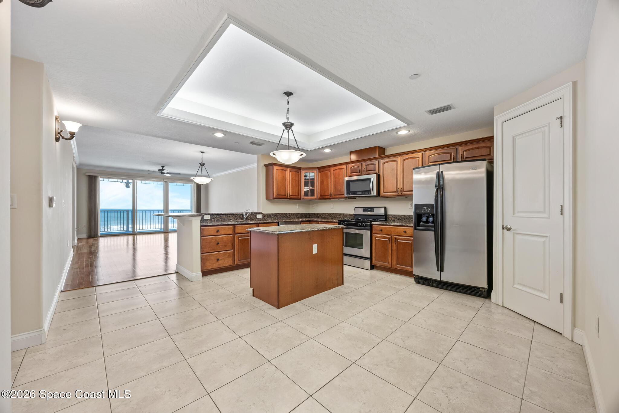 1 8th Avenue, Unit 1403 Indialantic, FL 32903 - Photo 37 of 69 a large kitchen with stainless steel appliances kitchen island granite countertop a stove a sink dishwasher and a refrigerator