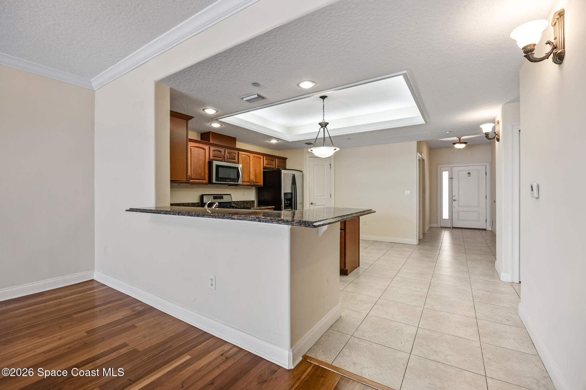 1 8th Avenue, Unit 1403 Indialantic, FL 32903 - Photo 38 of 69 a view of a kitchen with kitchen island wooden floor center island and stainless steel appliances