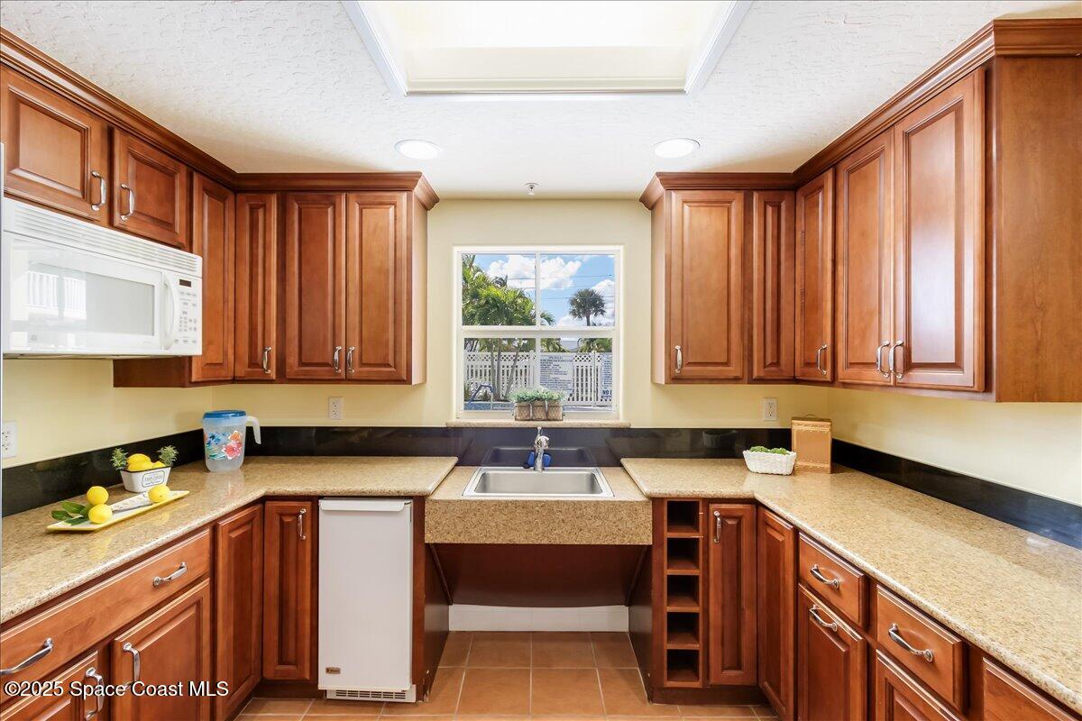 1 8th Avenue, Unit 1403 Indialantic, FL 32903 - Photo 4 of 69 a kitchen with a sink cabinets and window