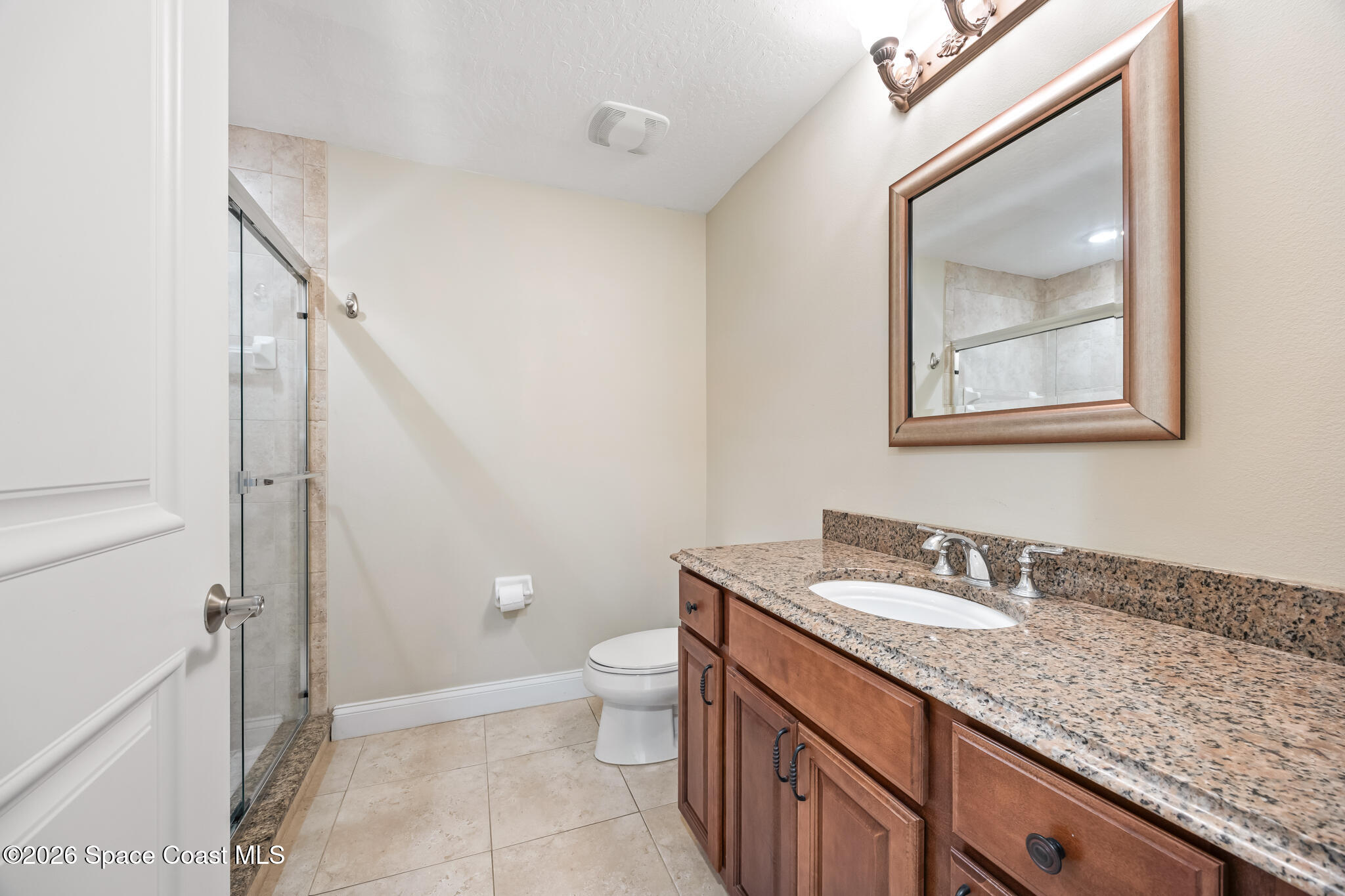 1 8th Avenue, Unit 1403 Indialantic, FL 32903 - Photo 54 of 69 a bathroom with a granite countertop sink a toilet and a mirror