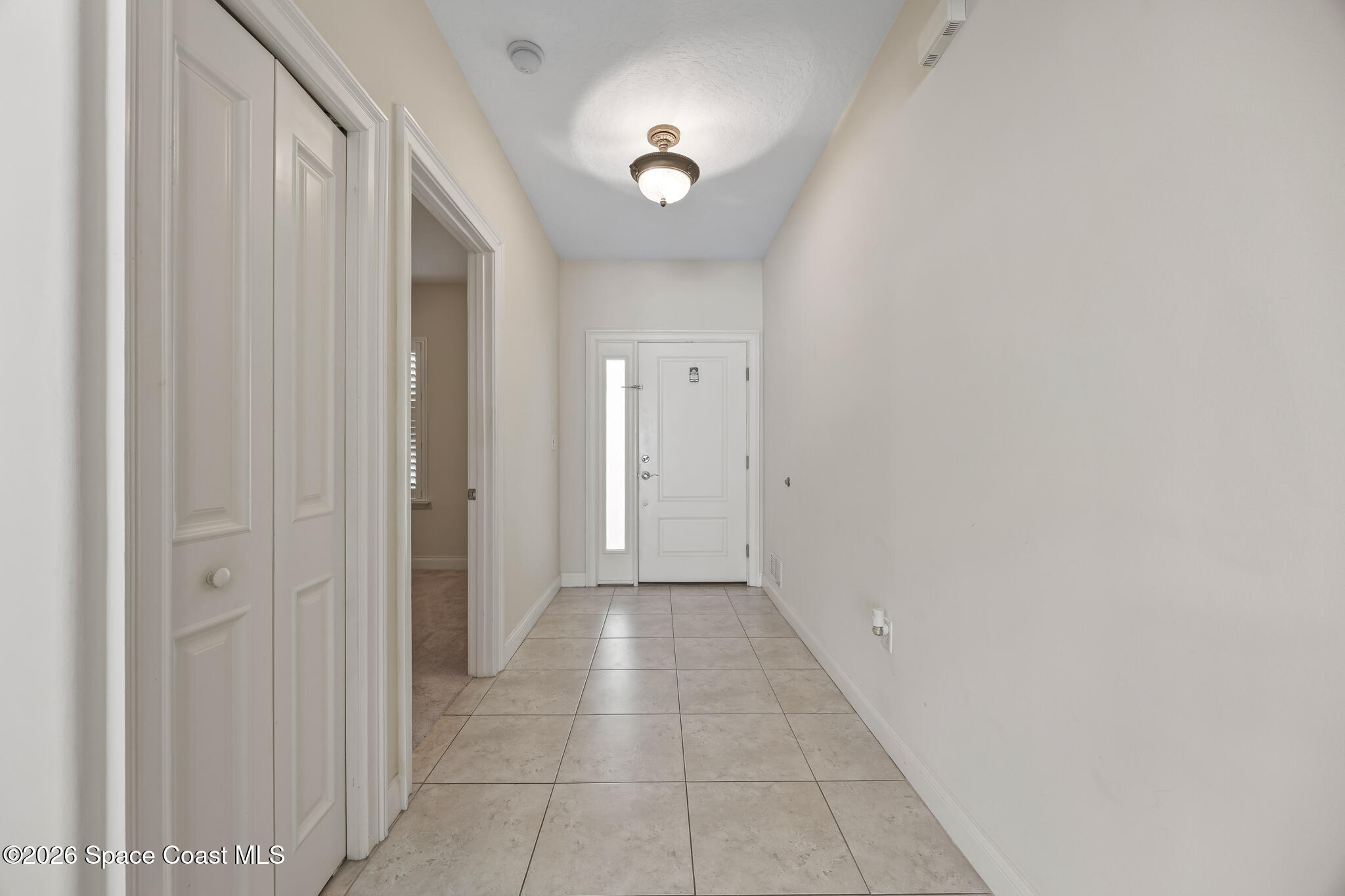 1 8th Avenue, Unit 1403 Indialantic, FL 32903 - Photo 57 of 69 a view of a hallway with a chandelier fan