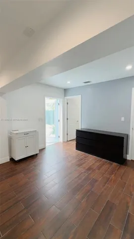 a view of an empty room and wooden floor