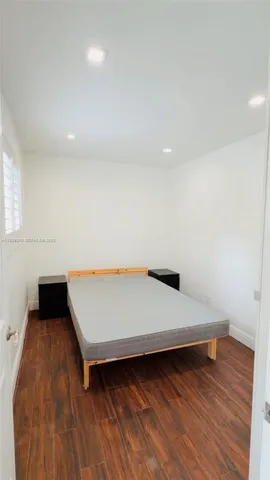 a room with wooden floor and staircase