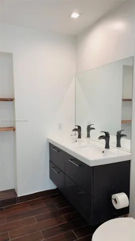 a bathroom with a sink and mirror