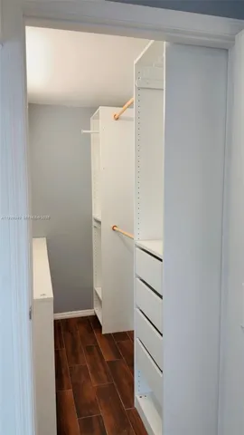 a view of walk in closet with empty racks