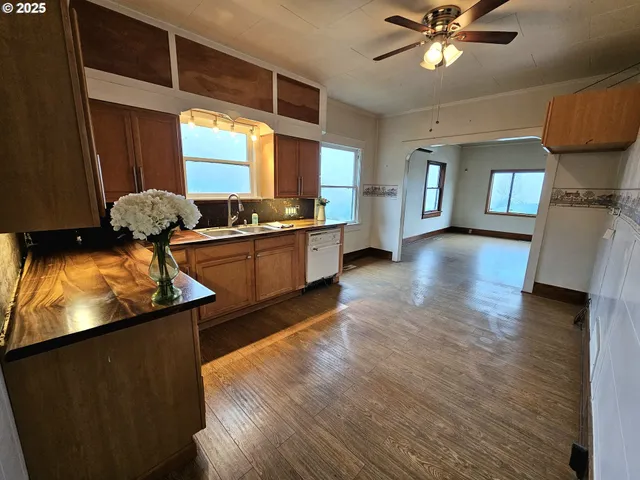a kitchen with stainless steel appliances granite countertop a sink and a stove