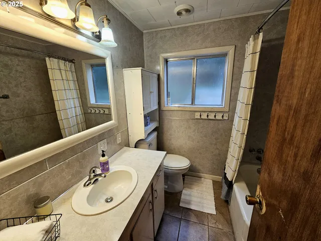 a bathroom with a sink toilet and mirror