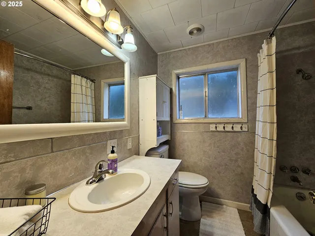 a bathroom with a sink toilet and mirror