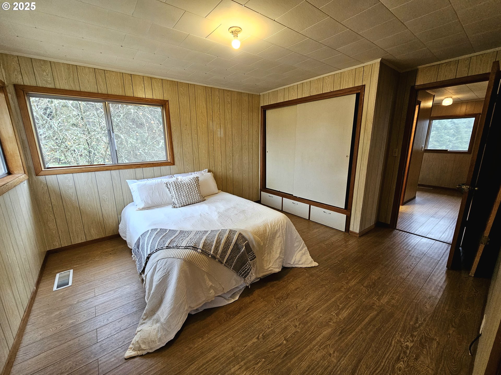 32373 Southwest JP W Road Scappoose, OR 97056 - Photo 22 of 44 a bedroom with a bed and wooden floor