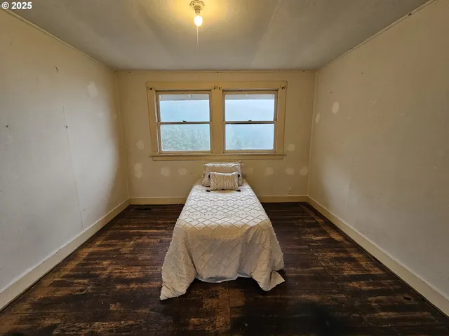 a bed sitting in a bedroom next to a window