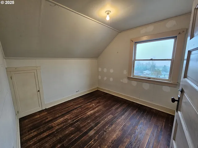 a view of an empty room and wooden floor