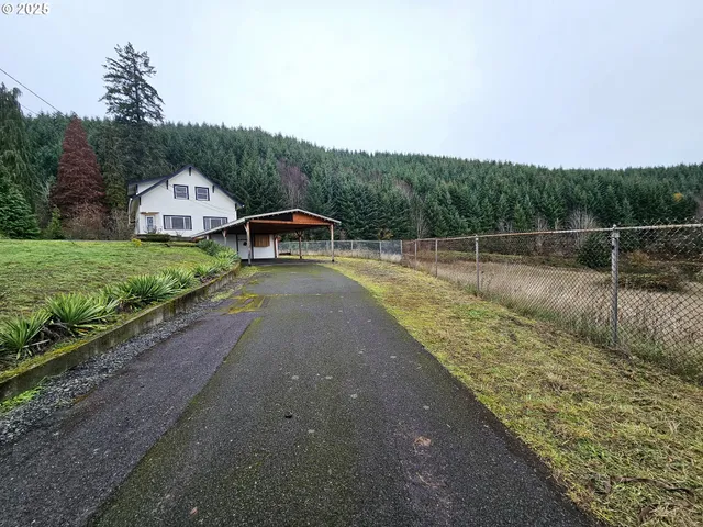 a backyard of a house with table and chairs