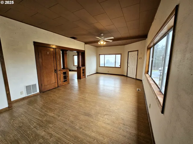 a view of an entryway with wooden floor and windows