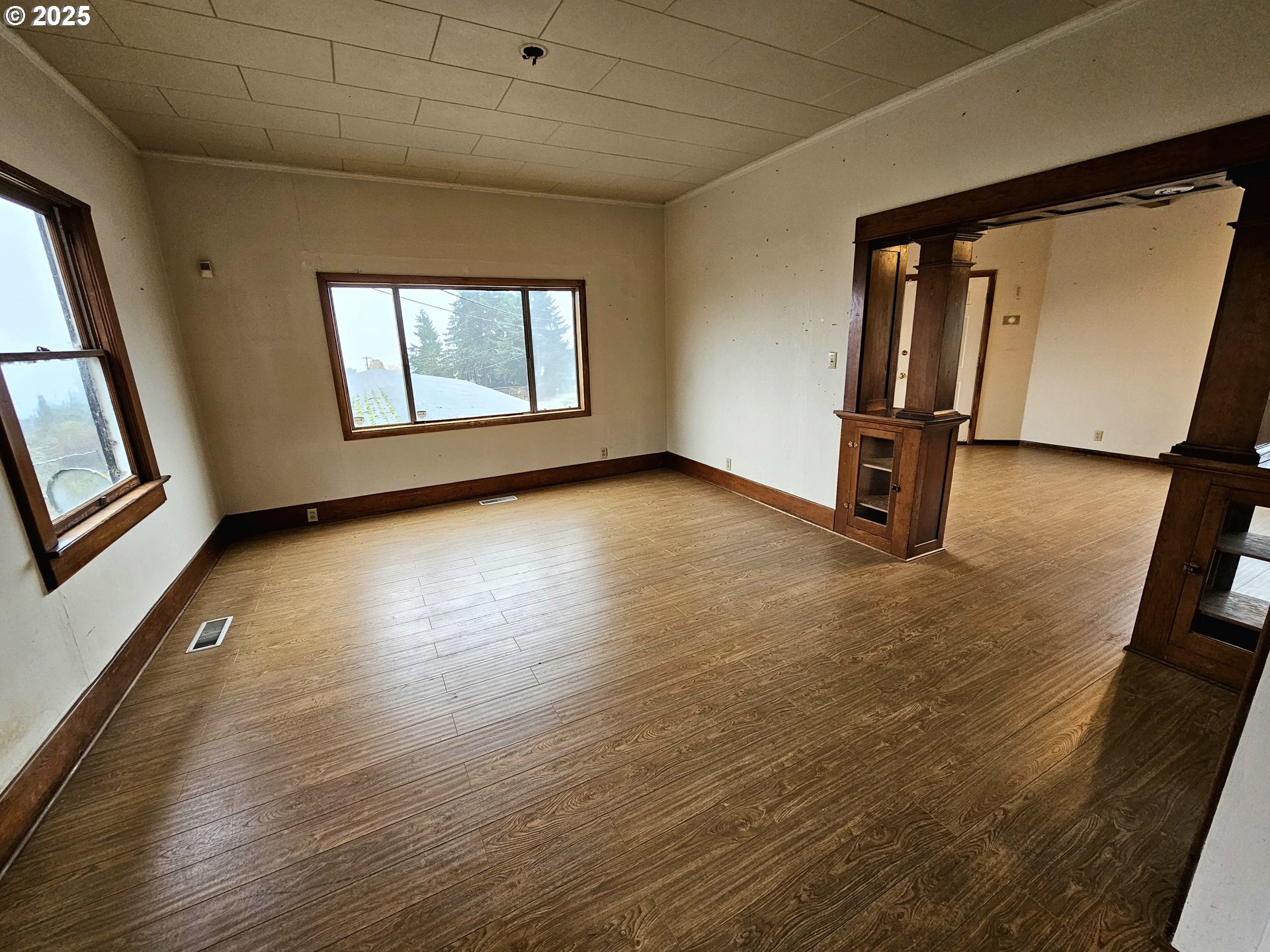 32373 Southwest JP W Road Scappoose, OR 97056 - Photo 8 of 44 a view of an empty room with a window and wooden floor