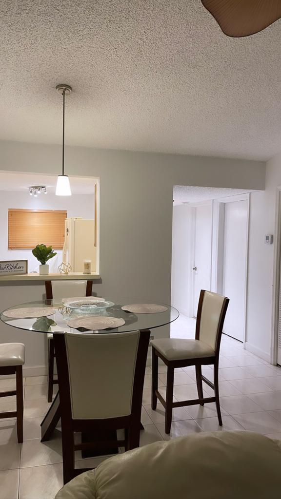 23466 Lyons Road, Unit 509 Boca Raton, FL 33428 - Photo 2 of 17 a view of a dining room with furniture and window