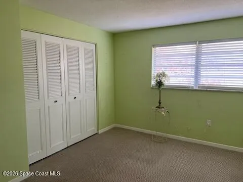 a view of an empty room with a chandelier