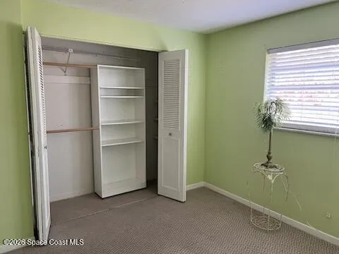 a view of an empty room with a bathroom