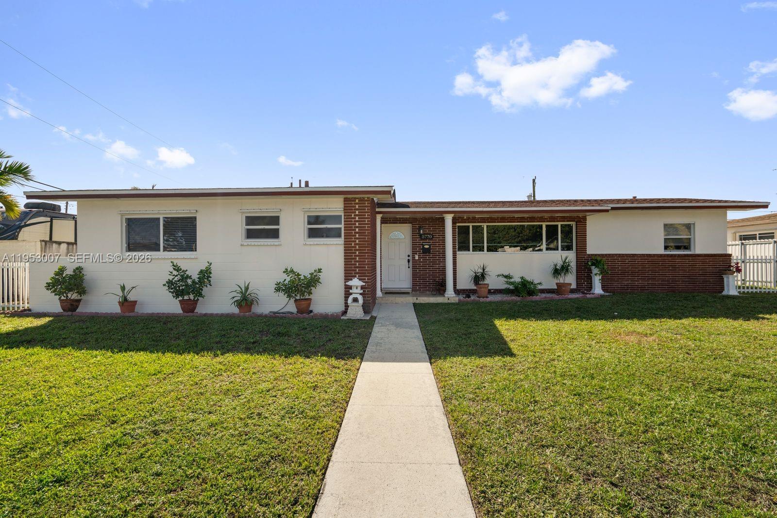 5770 Northwest 111th Street Hialeah, FL 33012 - Photo 1 of 32 a front view of a house with garden