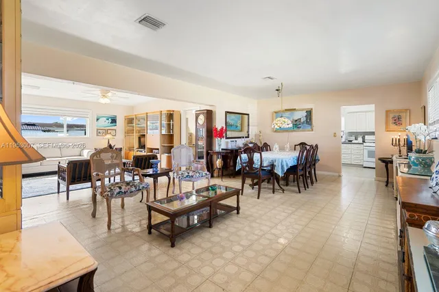 a living room with lots of furniture and kitchen view