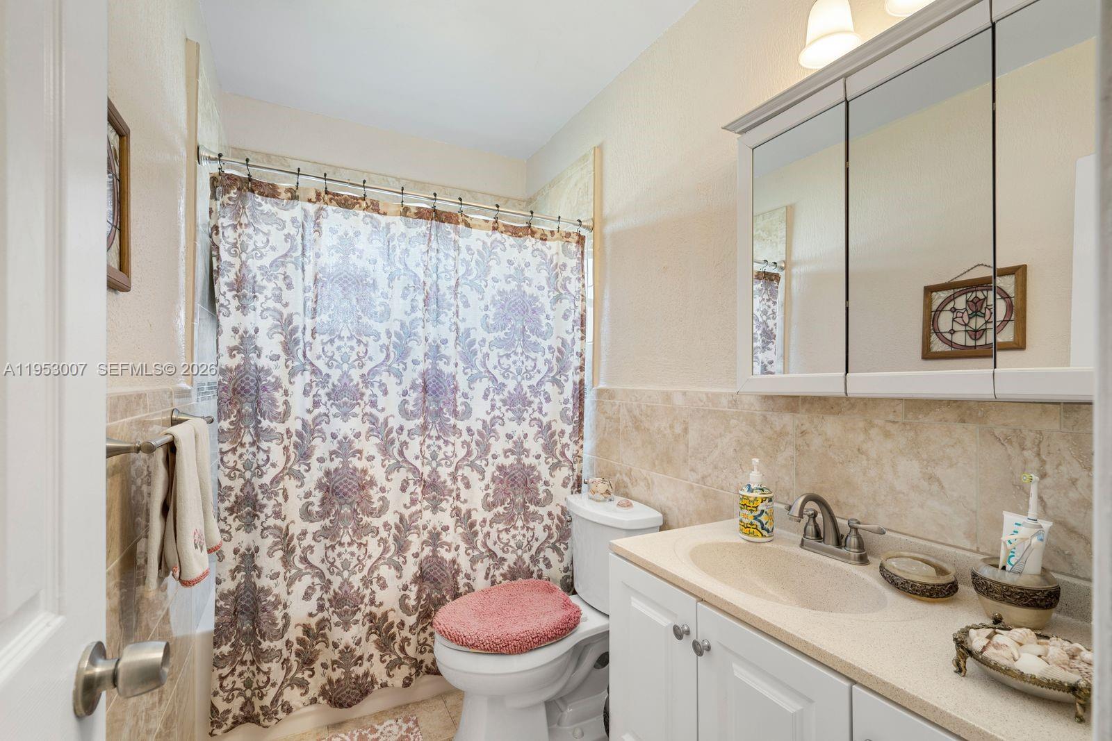 5770 Northwest 111th Street Hialeah, FL 33012 - Photo 13 of 32 a bathroom with a sink toilet and shower