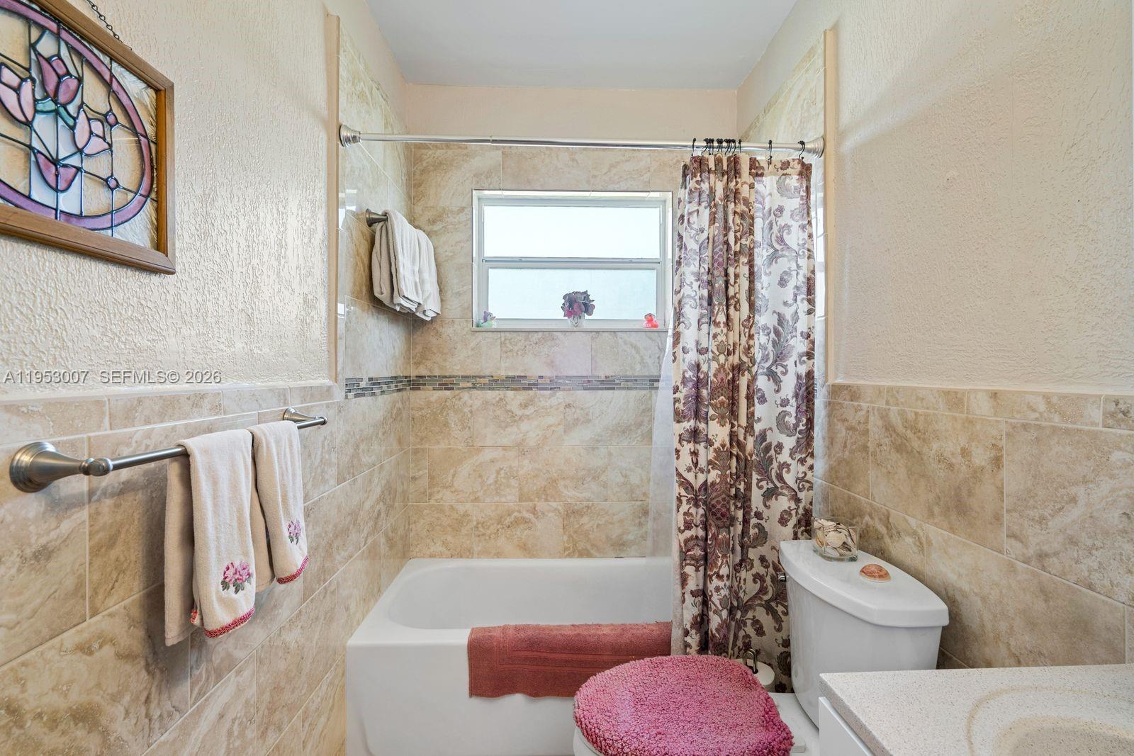 5770 Northwest 111th Street Hialeah, FL 33012 - Photo 14 of 32 a bathroom with a toilet and a shower