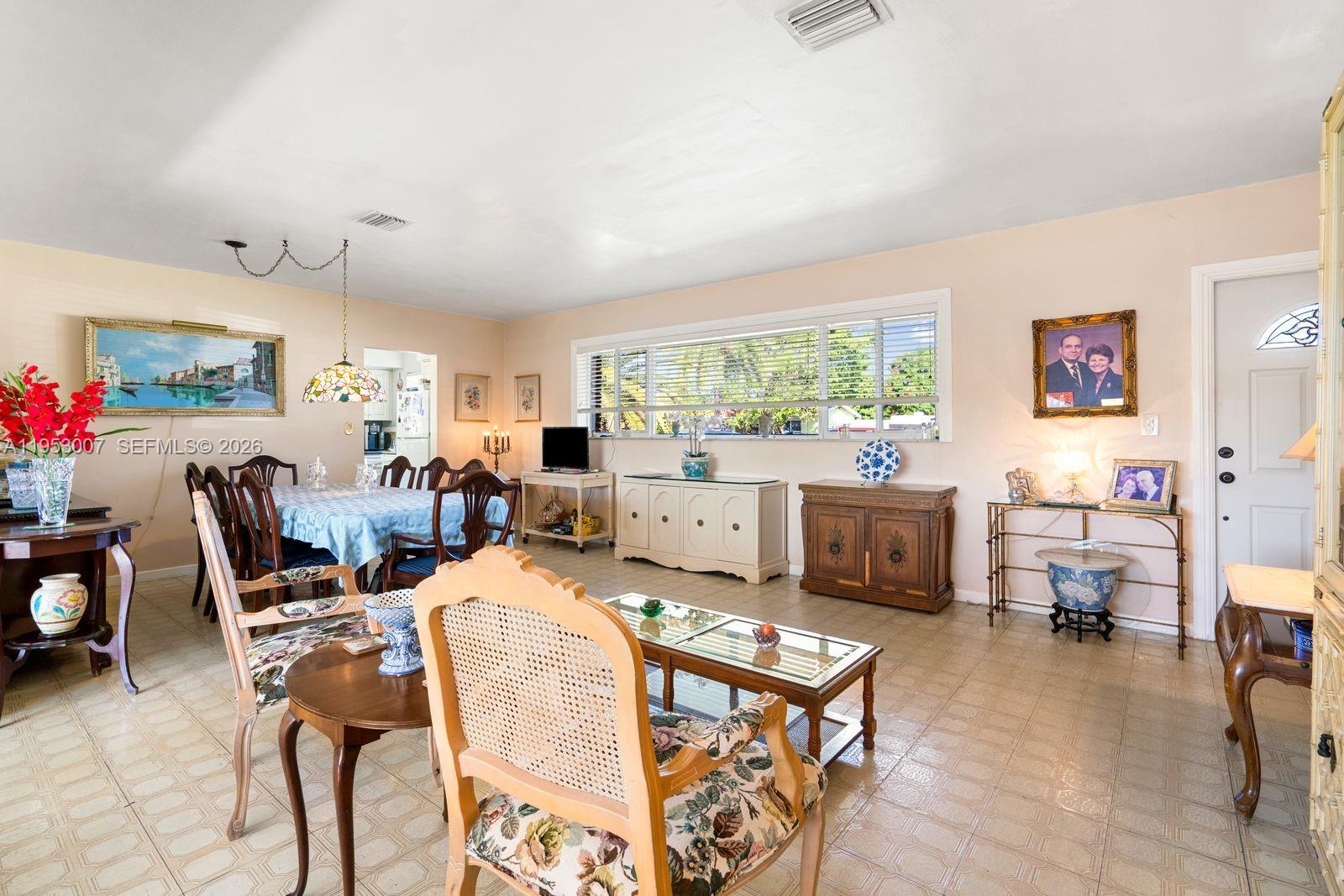 5770 Northwest 111th Street Hialeah, FL 33012 - Photo 15 of 32 a living room with furniture and a large window