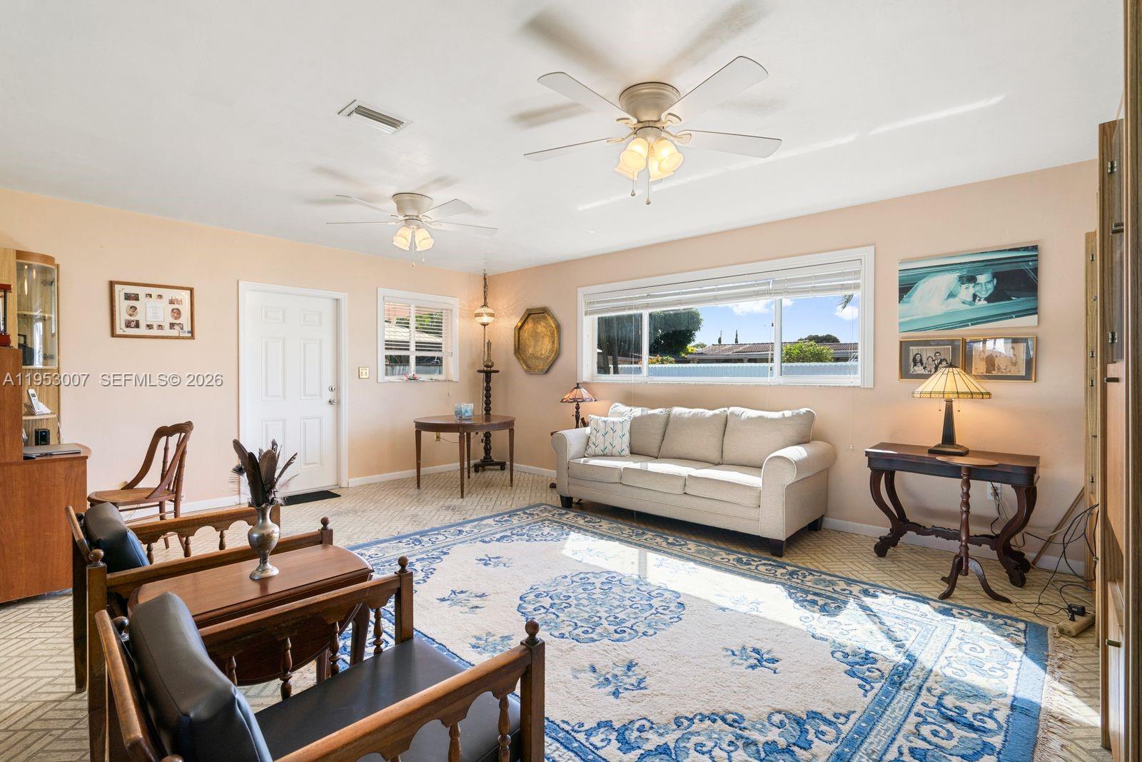 5770 Northwest 111th Street Hialeah, FL 33012 - Photo 17 of 32 a living room with furniture and a large window