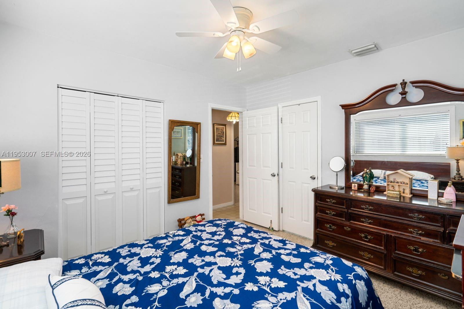 5770 Northwest 111th Street Hialeah, FL 33012 - Photo 22 of 32 a bedroom with a bed and a dresser with mirror