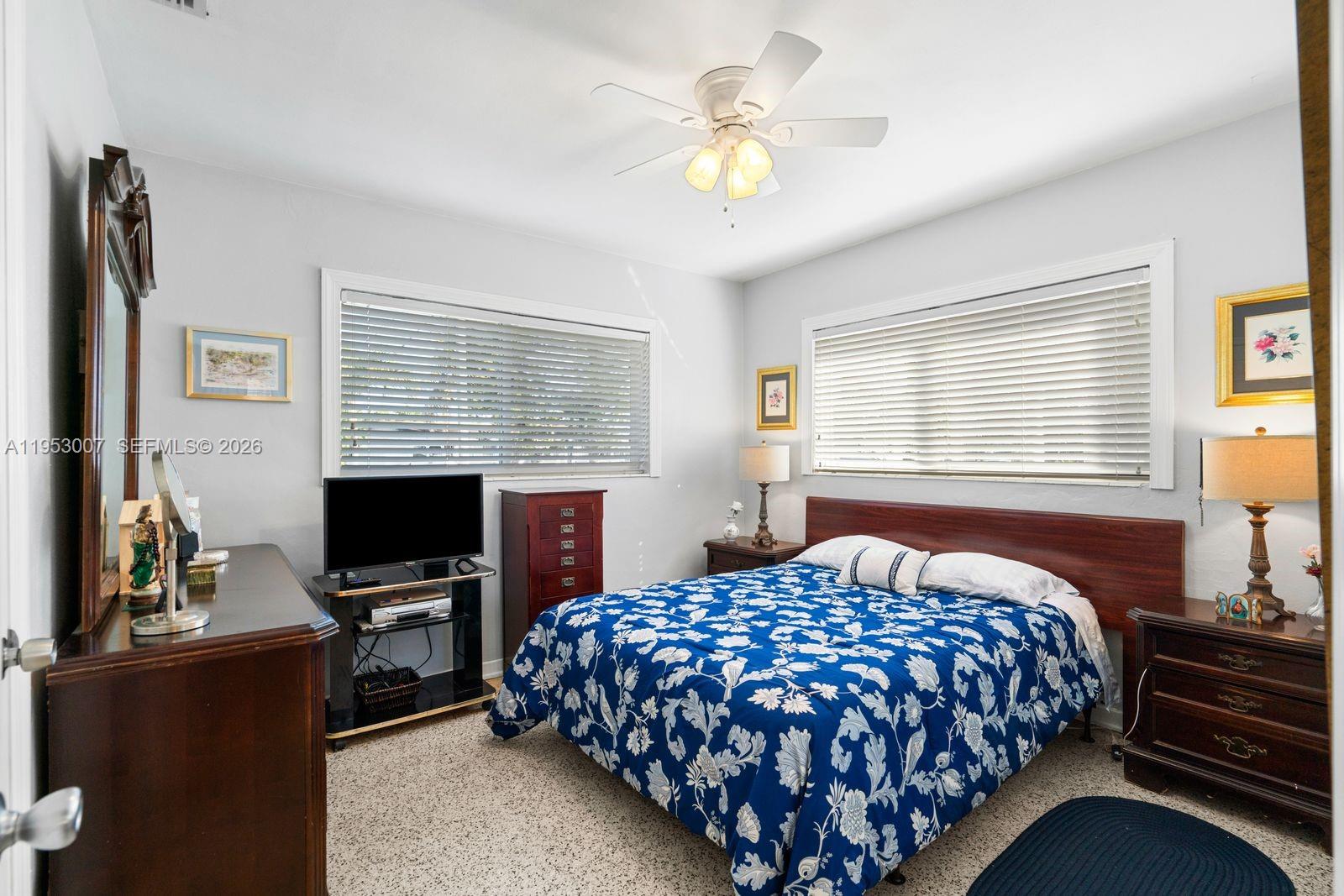 5770 Northwest 111th Street Hialeah, FL 33012 - Photo 23 of 32 a bedroom with a bed and a flat screen tv