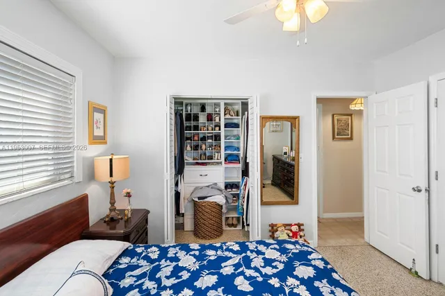 a bedroom with furniture and a window