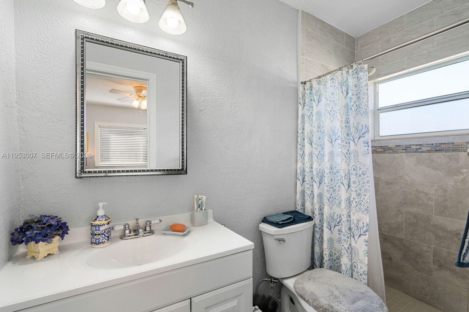 5770 Northwest 111th Street Hialeah, FL 33012 - Photo 25 of 32 a bathroom with a sink mirror and toilet