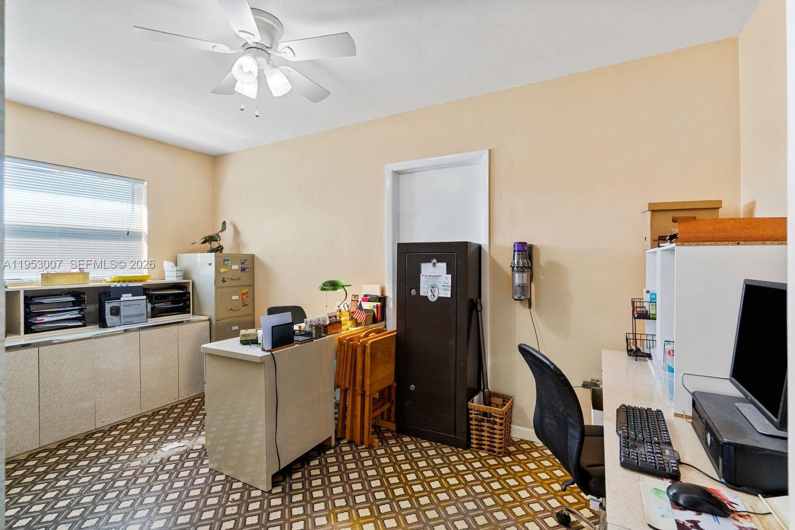 5770 Northwest 111th Street Hialeah, FL 33012 - Photo 31 of 32 a living room with furniture and a flat screen tv