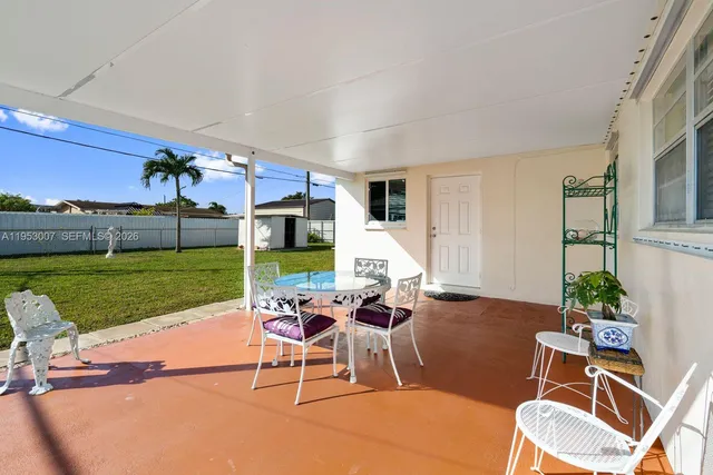 a view of a patio with a table and chairs