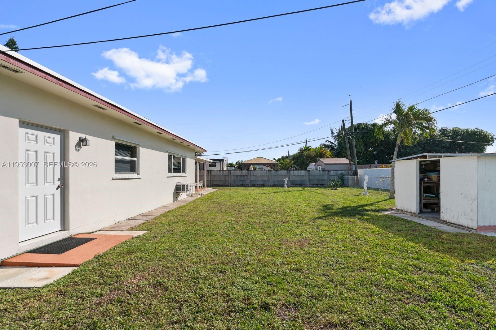 5770 Northwest 111th Street Hialeah, FL 33012 - Photo 8 of 32 a view of a house with a backyard