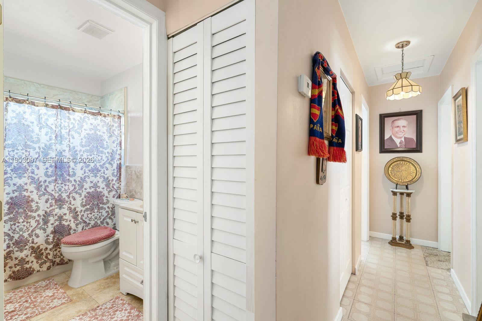 5770 Northwest 111th Street Hialeah, FL 33012 - Photo 10 of 32 a bathroom with a toilet and a shower curtain