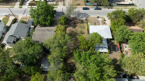 an aerial view of a house with a yard and trees