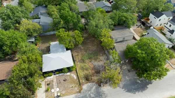 an aerial view of a house with garden space and street view