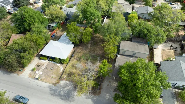 an aerial view of a house with a yard and garden