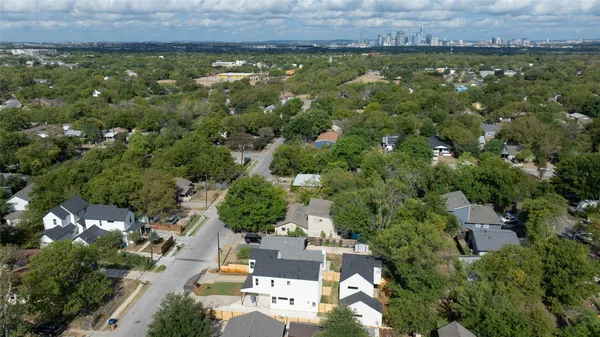 an aerial view of residential house with outdoor space and trees around