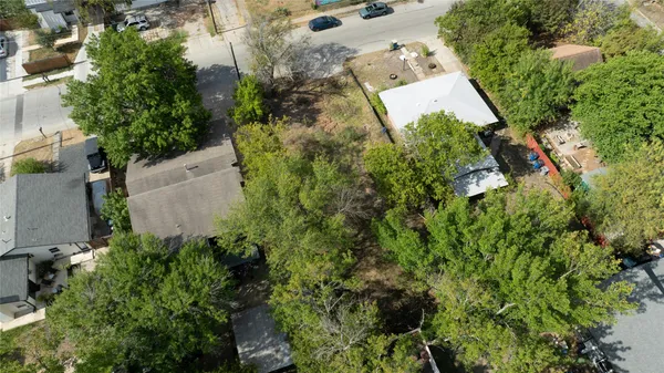 an aerial view of a house with a yard and garden
