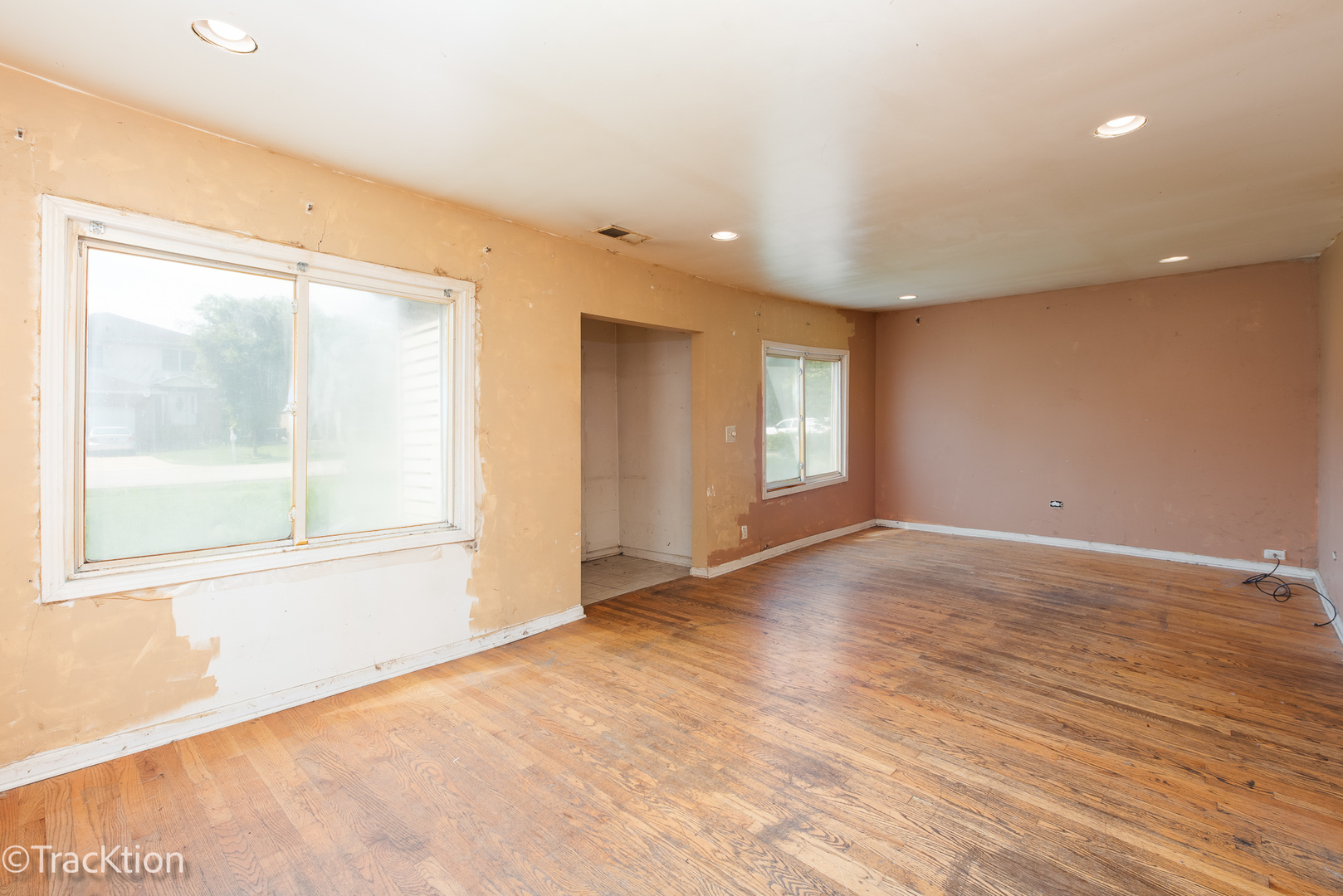 910 East Krage Drive Addison, IL 60101 - Photo 2 of 11 a view of an empty room with wooden floor and a window