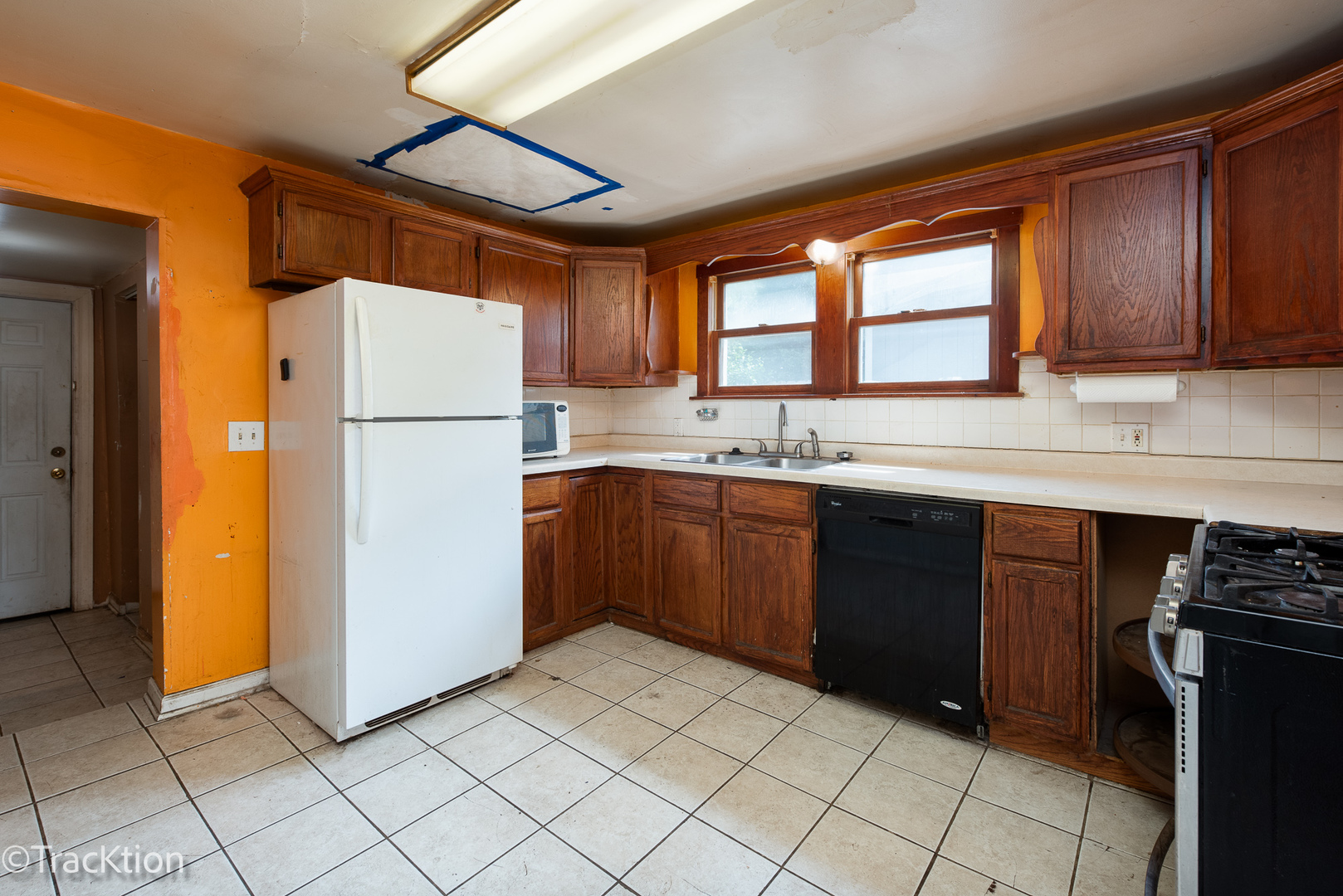 910 East Krage Drive Addison, IL 60101 - Photo 3 of 11 a kitchen with a refrigerator a stove top oven a sink and cabinets