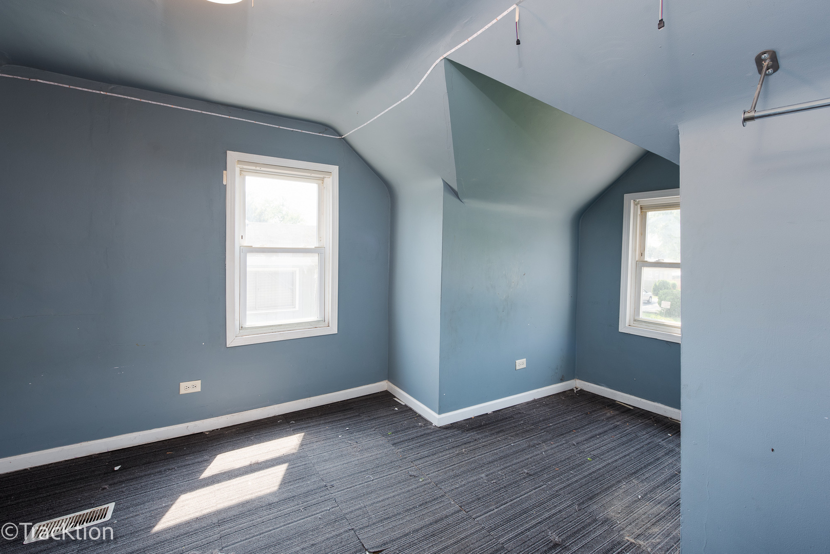 910 East Krage Drive Addison, IL 60101 - Photo 7 of 11 an empty room with wooden floor and windows