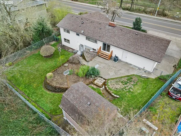 an aerial view of a house with a yard